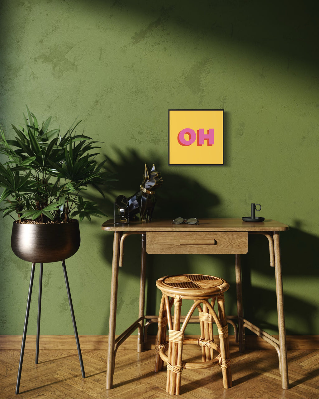 Small wooden desk with a plant, mug, and decorative items against a green wall with a 'OH' sign.