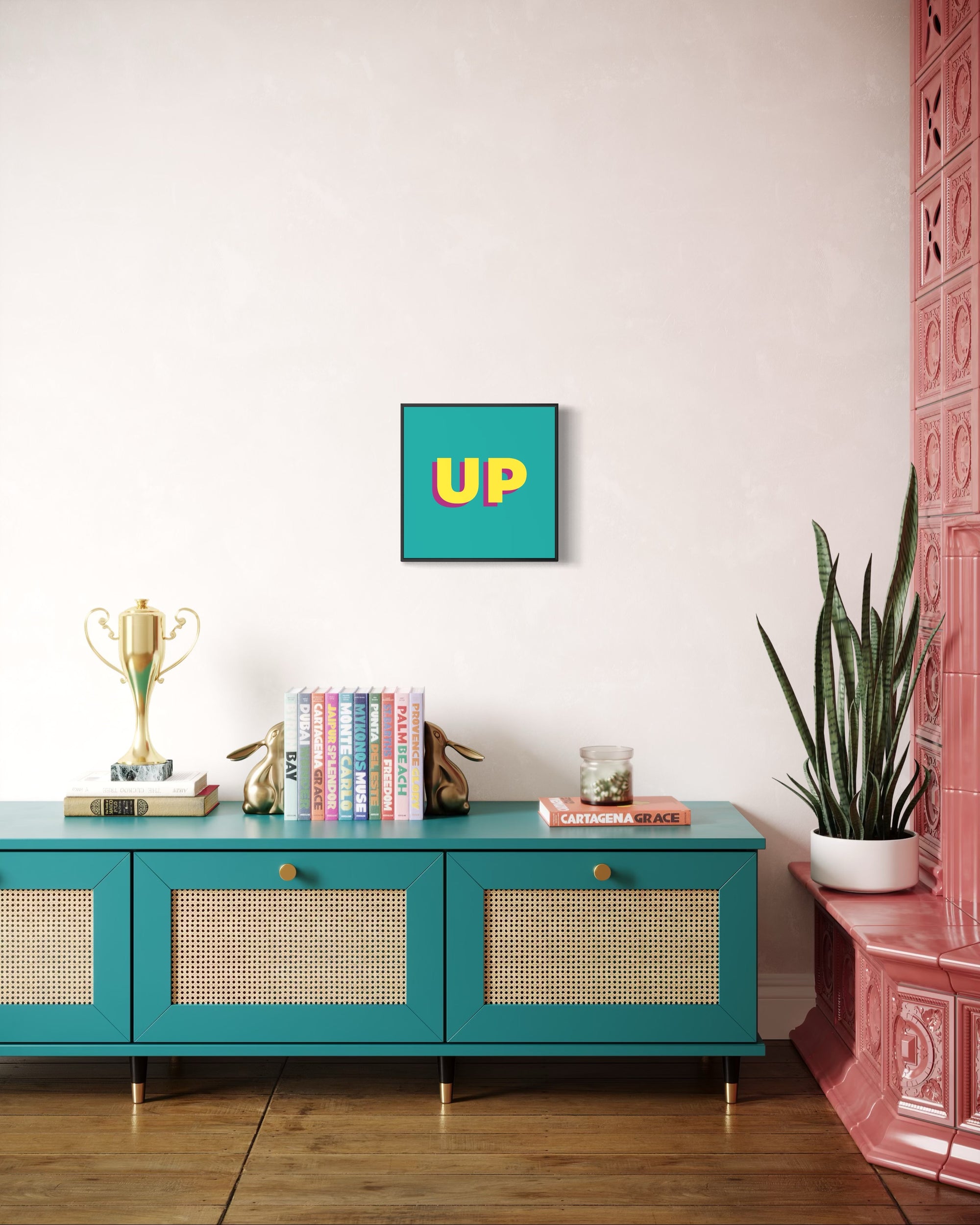 Teal console table with decorative items against a white wall with a colorful 'UP' framed picture.