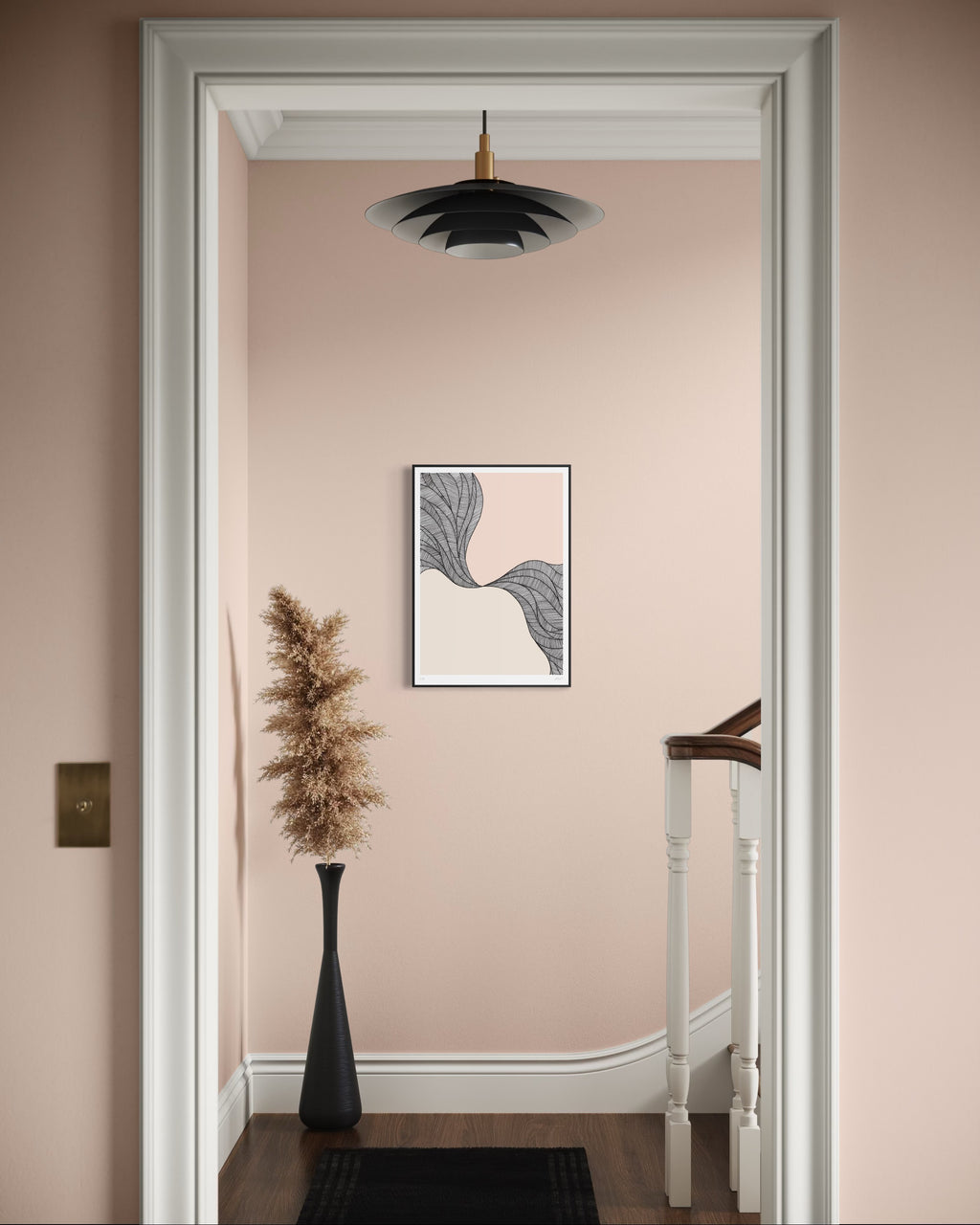 Decorative interior with a framed abstract art piece on a pink wall.