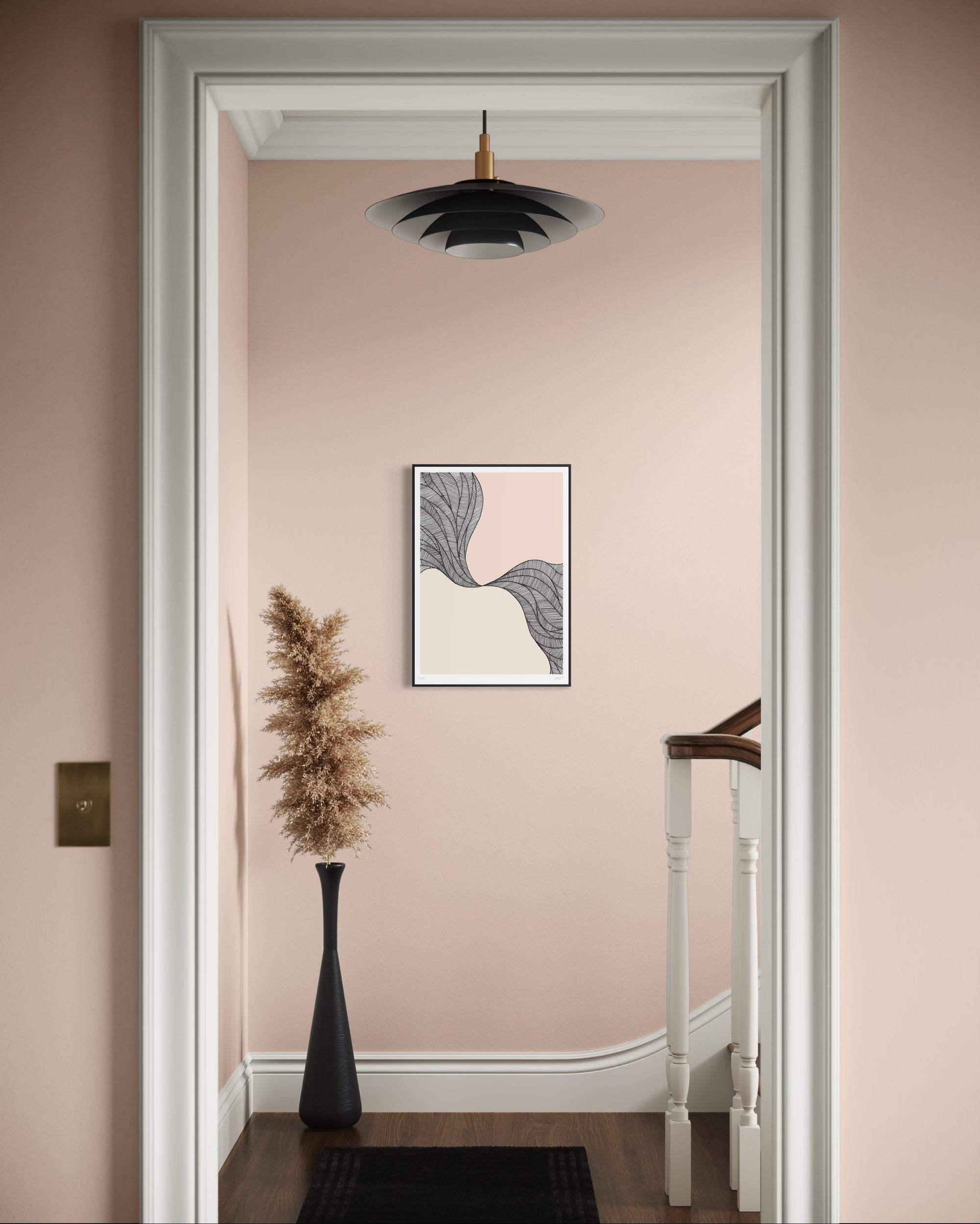 Decorative interior with a framed abstract art piece on a pink wall.