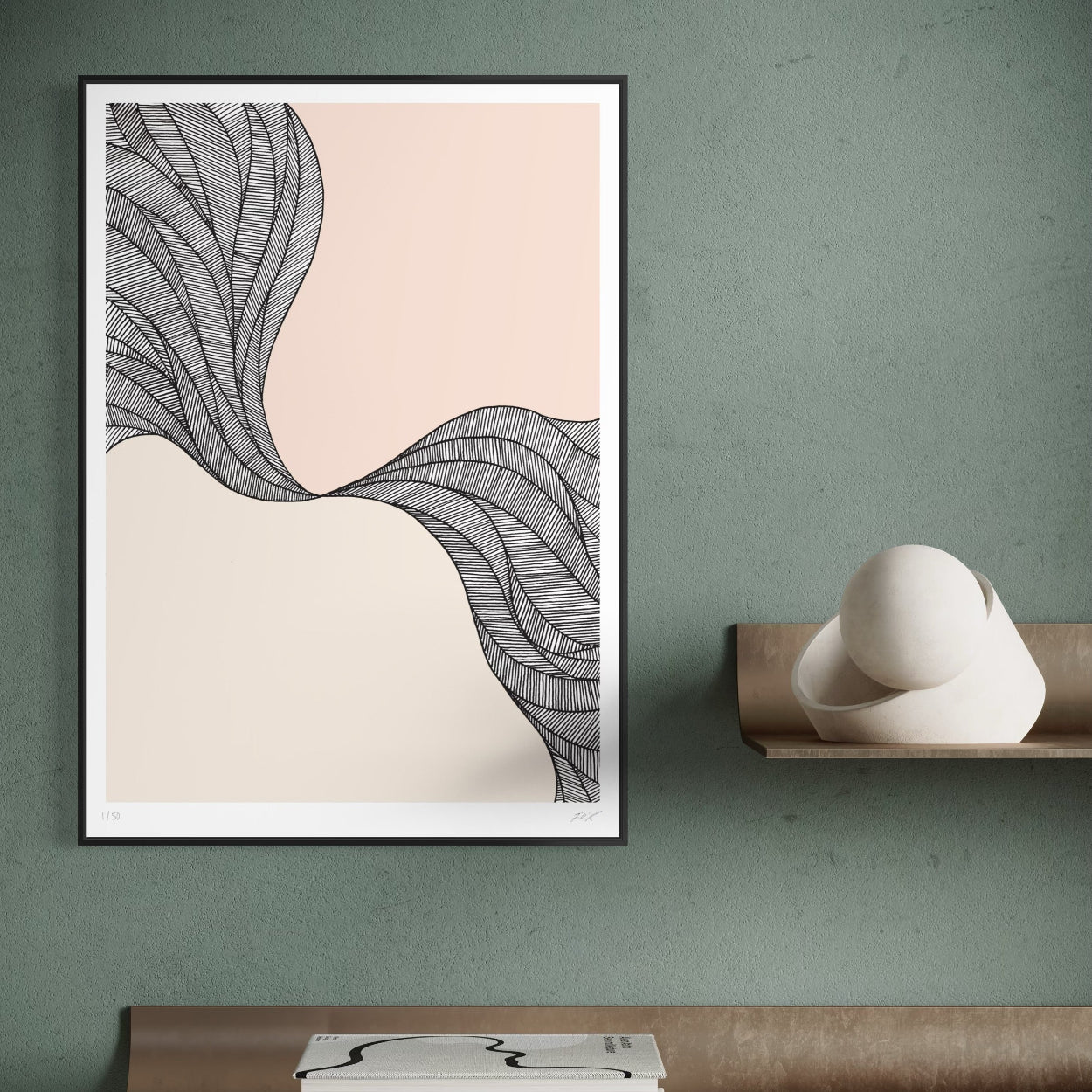 Framed abstract art print on a wall with a sculpture below.
