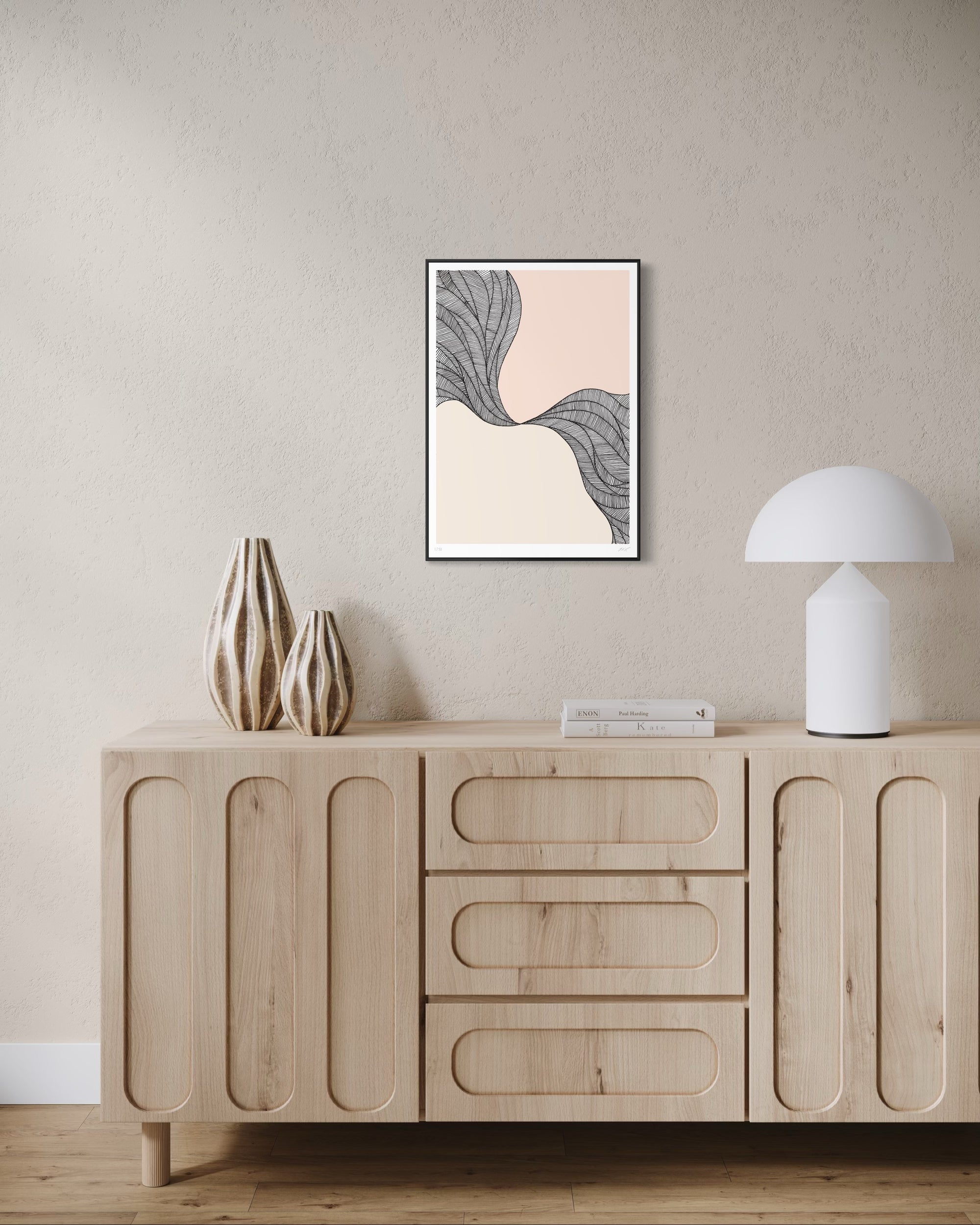 Wooden sideboard with decorative items and abstract art on a beige wall.